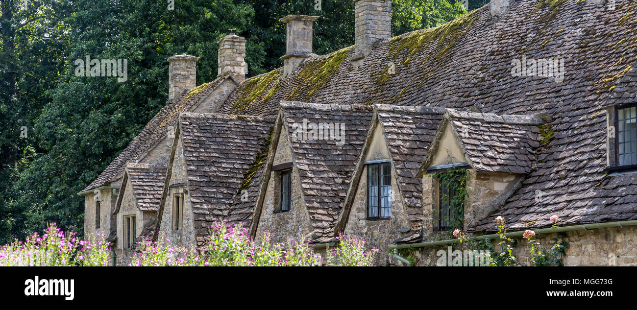 Bibury village's slate roofed row of dormers poke out of their Jacobean architecture Stock Photo