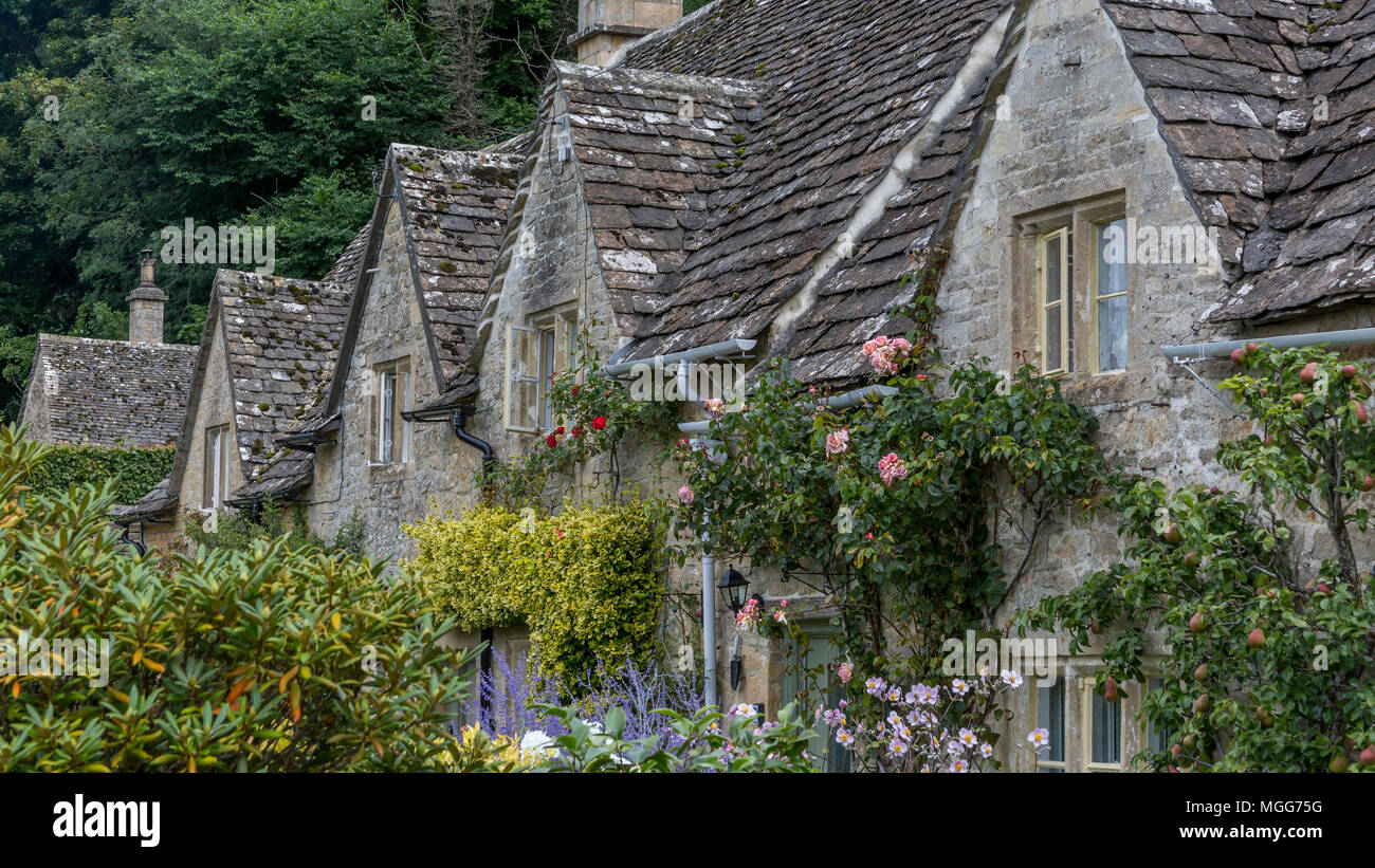 Bibury village's slate roofed row of dormers poke out of their Jacobean architecture Stock Photo