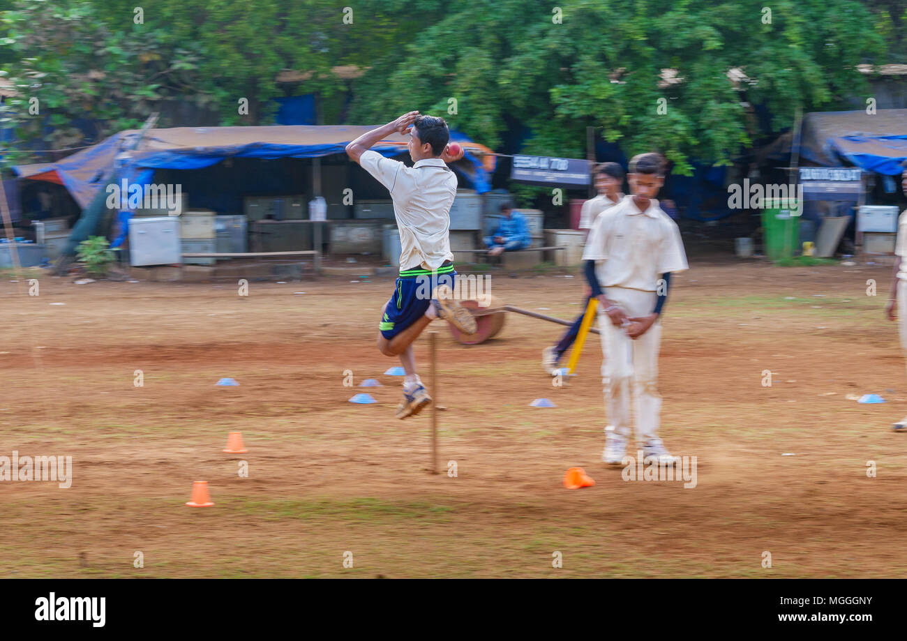 Mumbai, India - April 21, 2018: Unidentified boy practicing fast bowling to improve cricketing skills at Mumbai ground Stock Photo