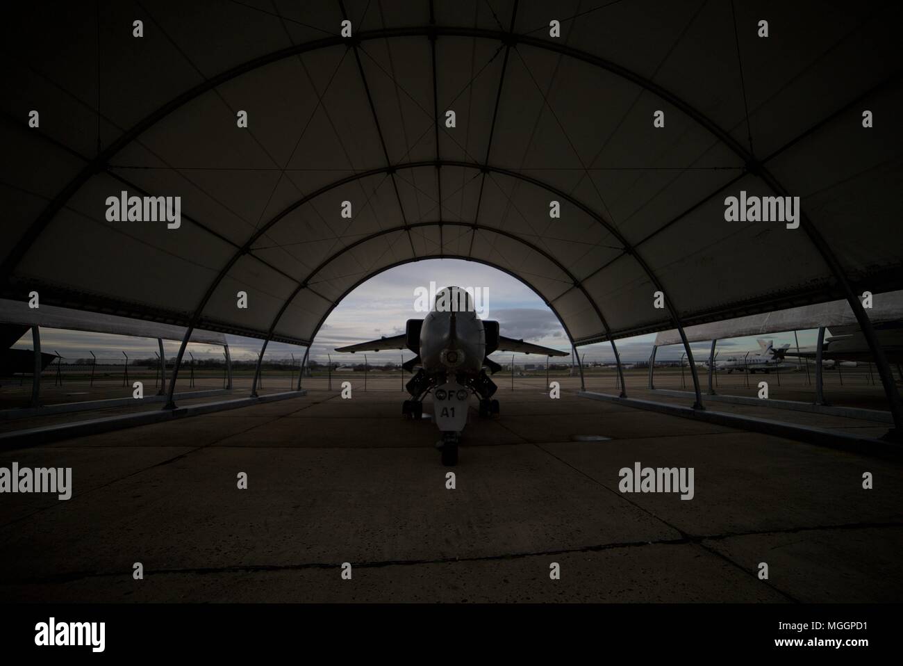 Fighter Jet in a hangar, plane inside hangar, silhouette of plane inside hangar at the Musée de l’air et de l’espace, Le Bourget, Dugny, France. Stock Photo