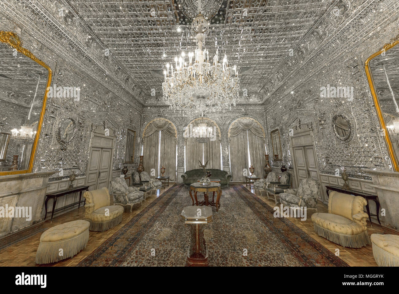 Scenic mirror hall in the Golestan Palace in Tehran, Iran. The walls and the ceiling of the hall are decorated with pieces of mirrors and glass. Stock Photo
