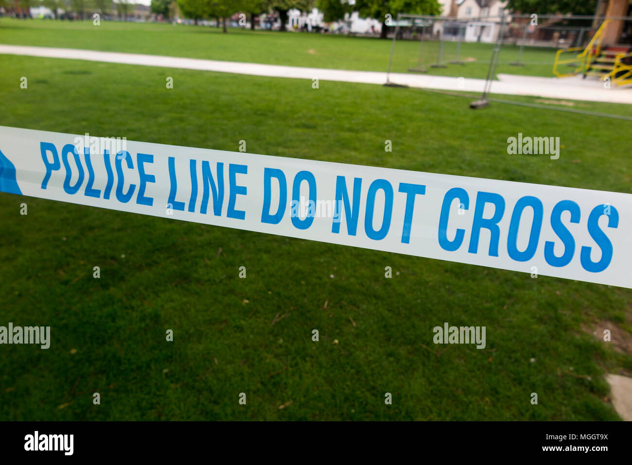 Police Line Do Not Cross tape barrier, typically placed around a crime