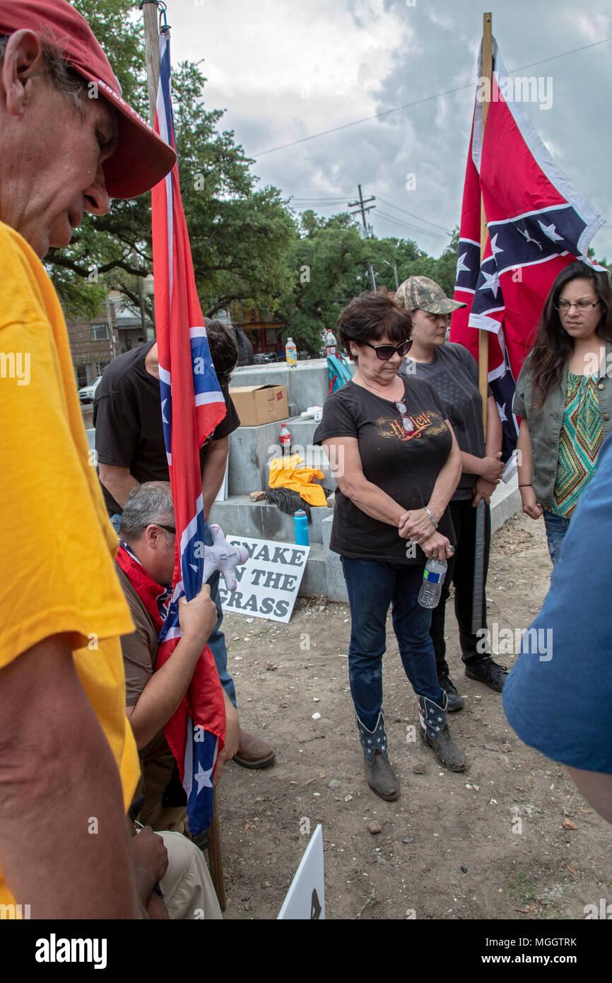 New Orleans, Louisiana - Carrying various Confederate flags, a small group prays at the site where a statue of Jefferson Davis was removed in 2017. Je Stock Photo