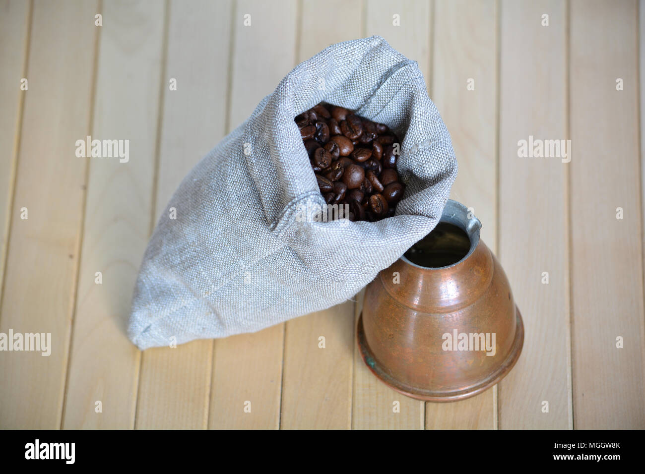 Pouch of coffee beans and a simple Turkish brewing pot Stock Photo