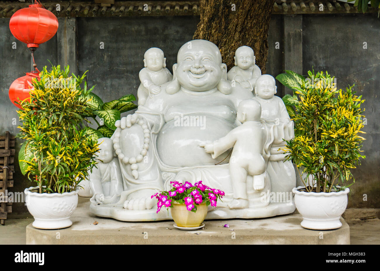 white statue of the Happy Buddha Stock Photo
