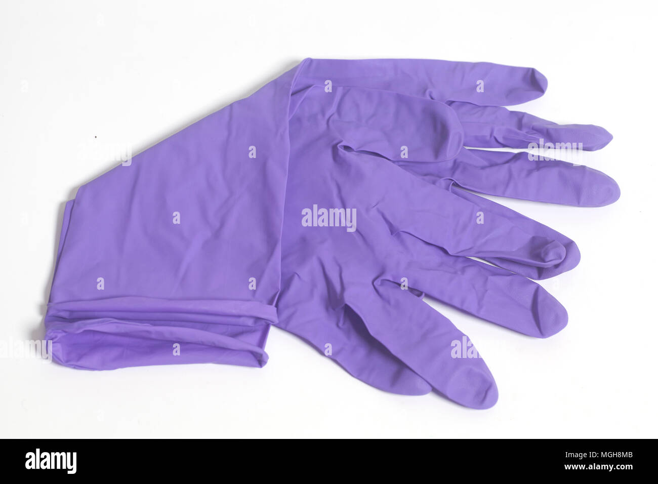 Purple latex gloves isolated on a white background Stock Photo Alamy