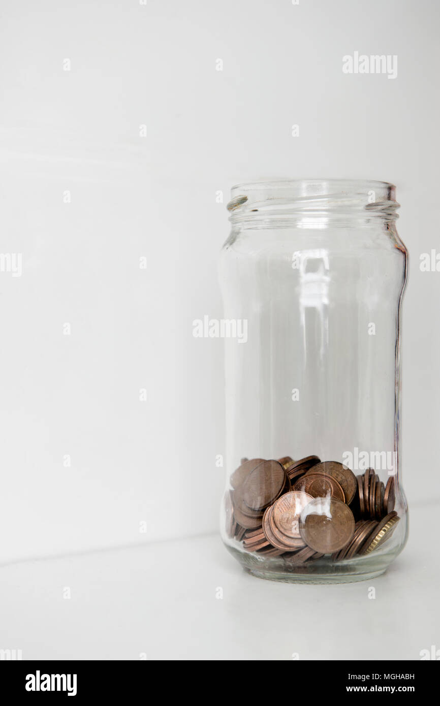 Concept of low funds using a jar of coins Stock Photo