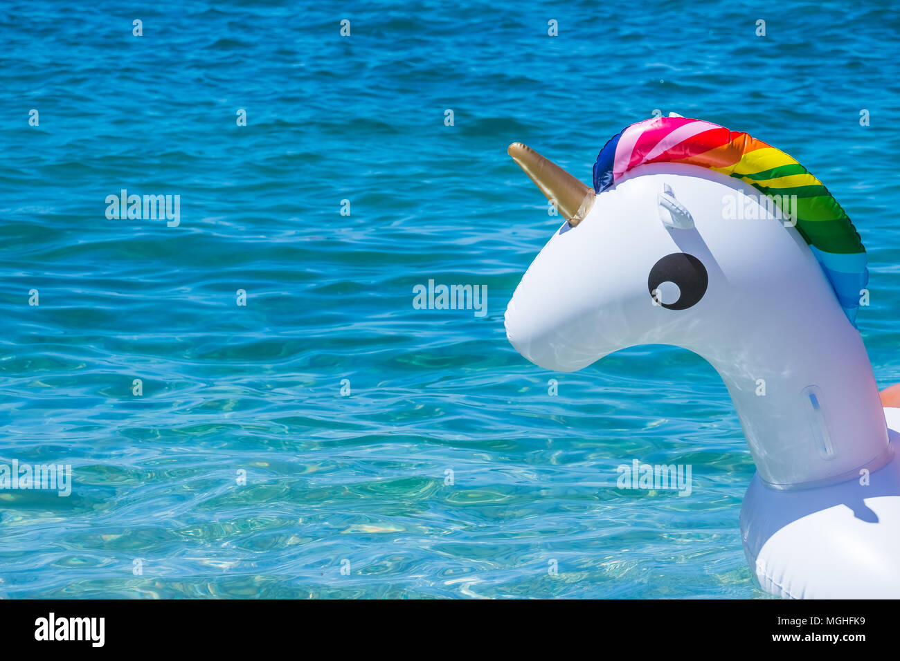 Unicorn swim tube on water background. Inflatable unicorn.Fantasy Swim