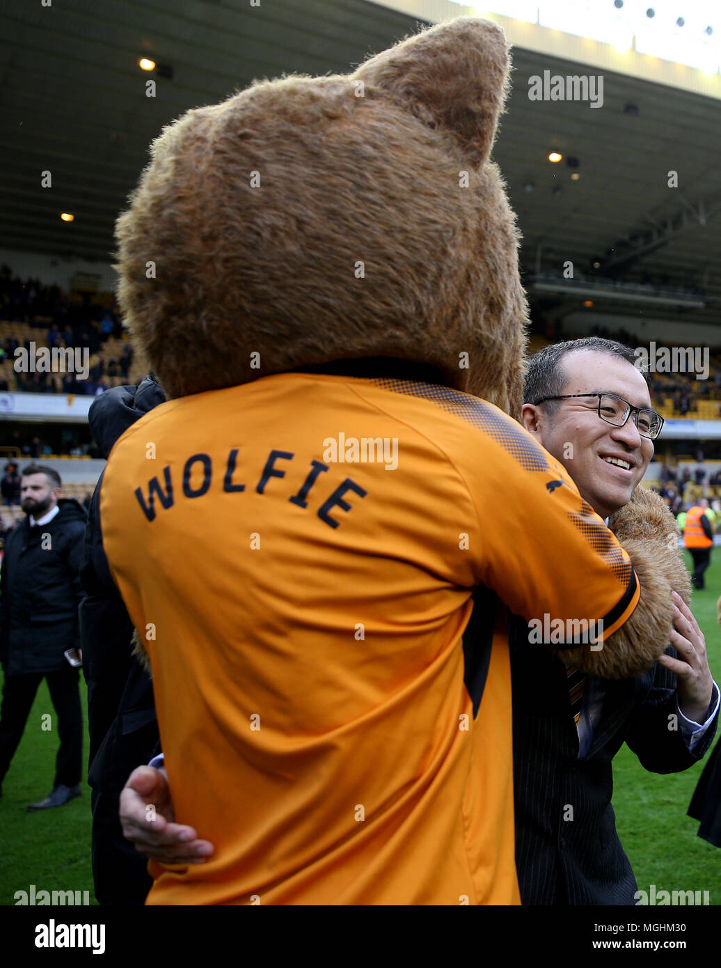Mascot Wolfie celebrates with Executive Chairman Jeff Shi after the Sky Bet Championship match at Molineux, Wolverhampton. Stock Photo