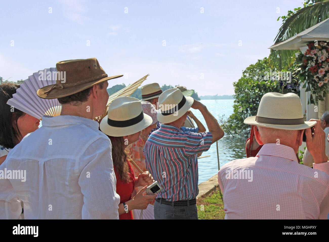 People wearing Panama hats to keep cool at a summer wedding event on a warm  summers day next to a lake Stock Photo - Alamy