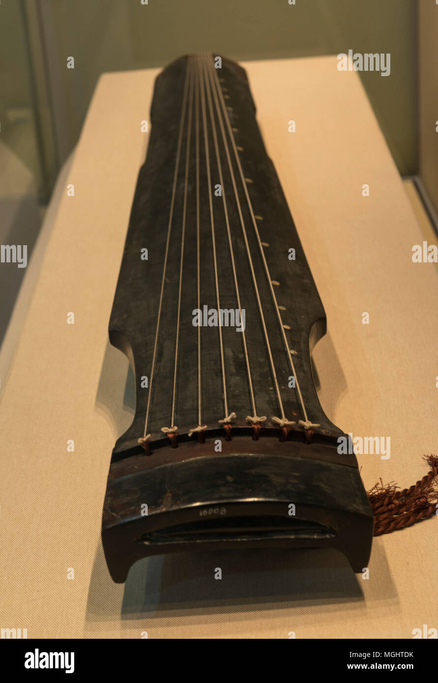 Zhongni form Guqin named Hao Zhong (Horn-bell) from Song Dynasty (960–1279) in Zhejiang Museum, China. Guqin is an ancient seven-stringed plucked instrument. Stock Photo