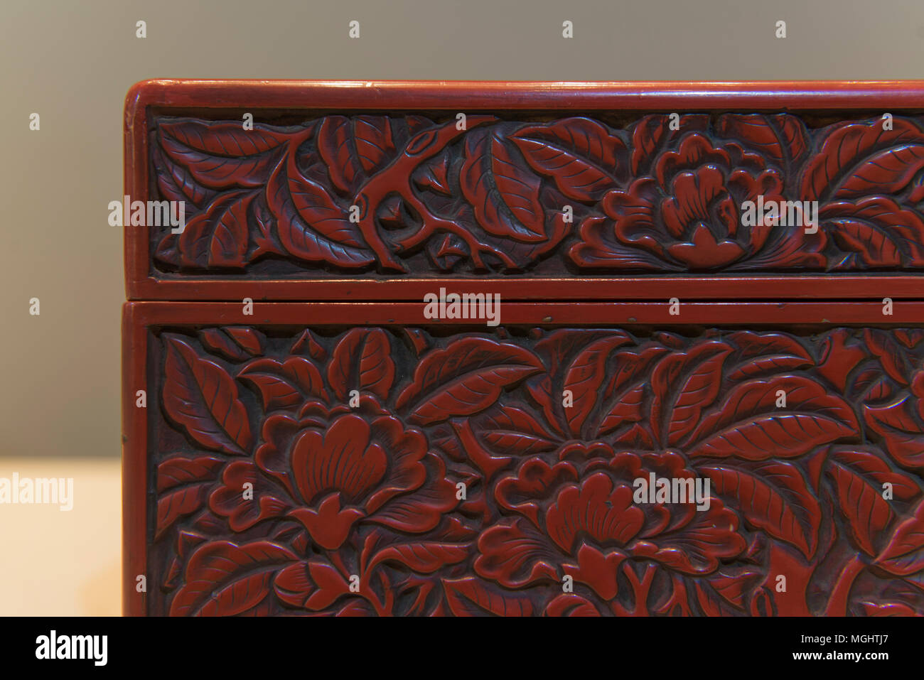 A rectangular vermilion box with craft of carved lacquer over wood from