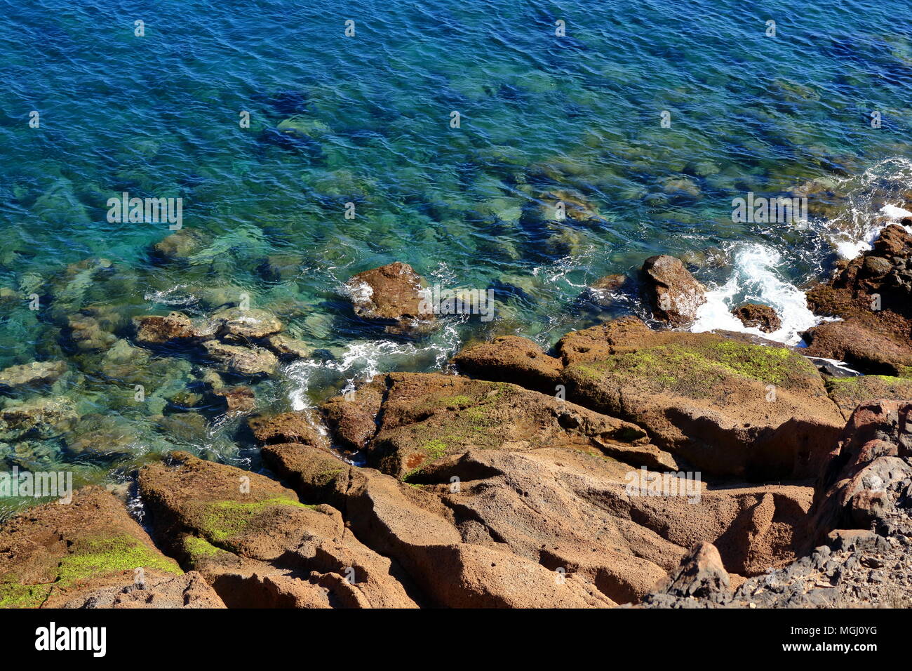 Image of blue ocean water and volcanic rocks. Stones under water Stock ...