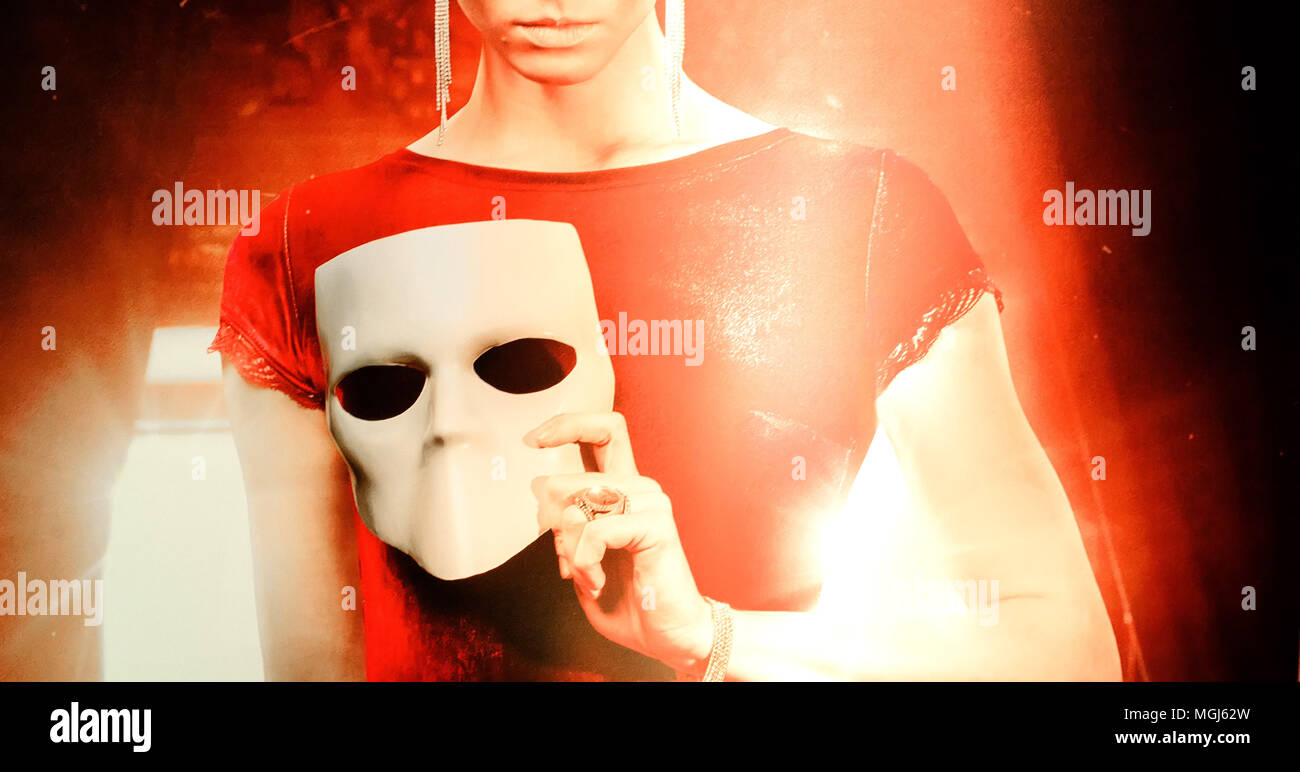 young woman holding mask.Faceless concept. Person without face. Stock Photo
