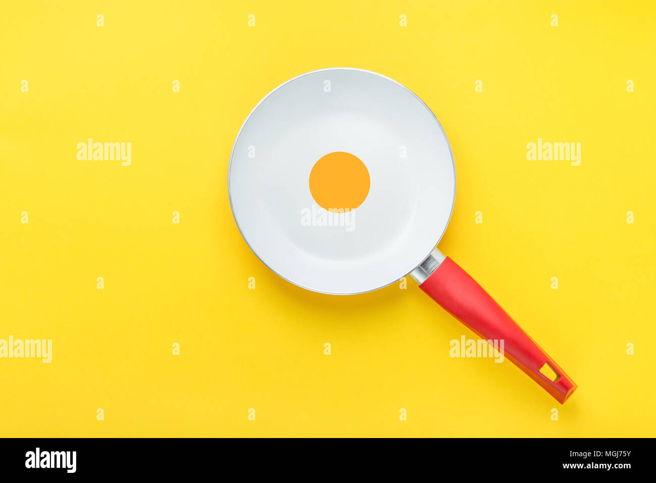 White Ceramic Frying Pan with Red Handle on Bright Yellow Background. Yolk in the Middle. Sunny Side Up Fried Eggs Collage. Creative Styled Image. Bre Stock Photo