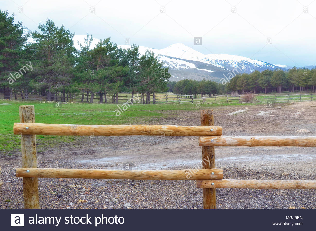Weather In Guadarrama Mountain Range Madrid Spain Forefront Of Natural Wood Mountain Fence Wintry Day In Spring Season Weather In Guadarrama Mountain Range Madrid Spain Forefront Of Natural Wood Mountain Fence Wintry Day In Spring Season