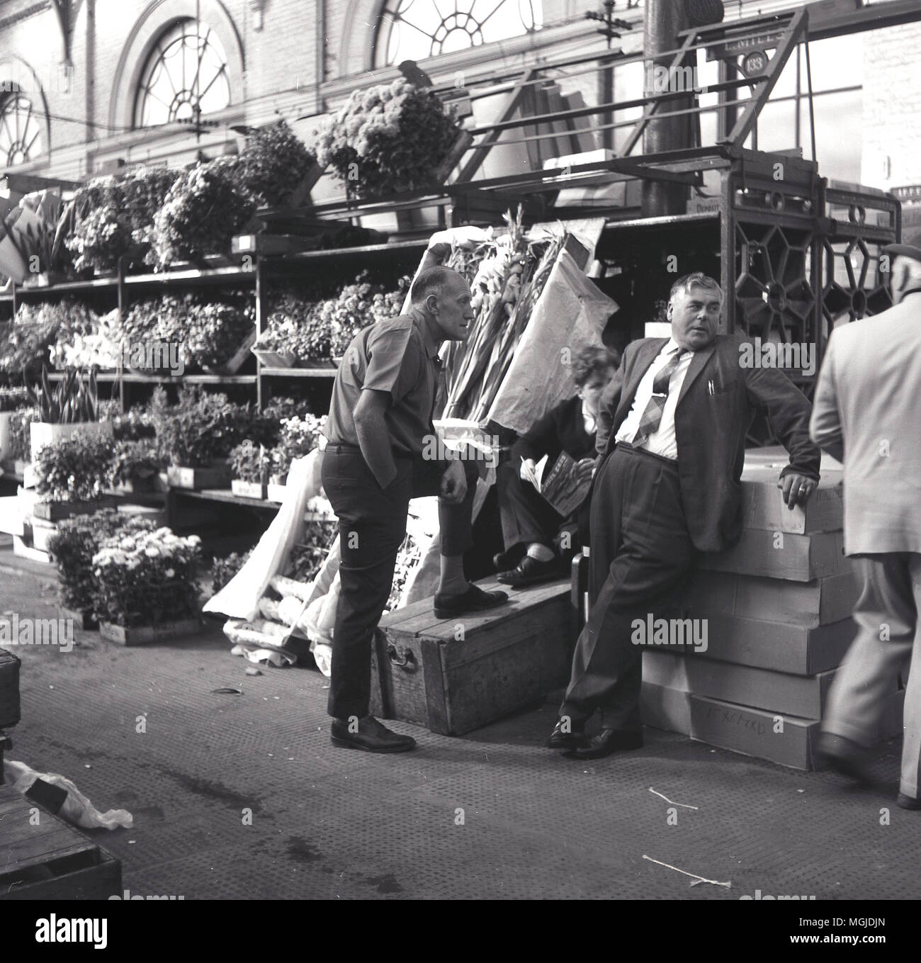 1960s, historical, flower traders outside their stall at london's