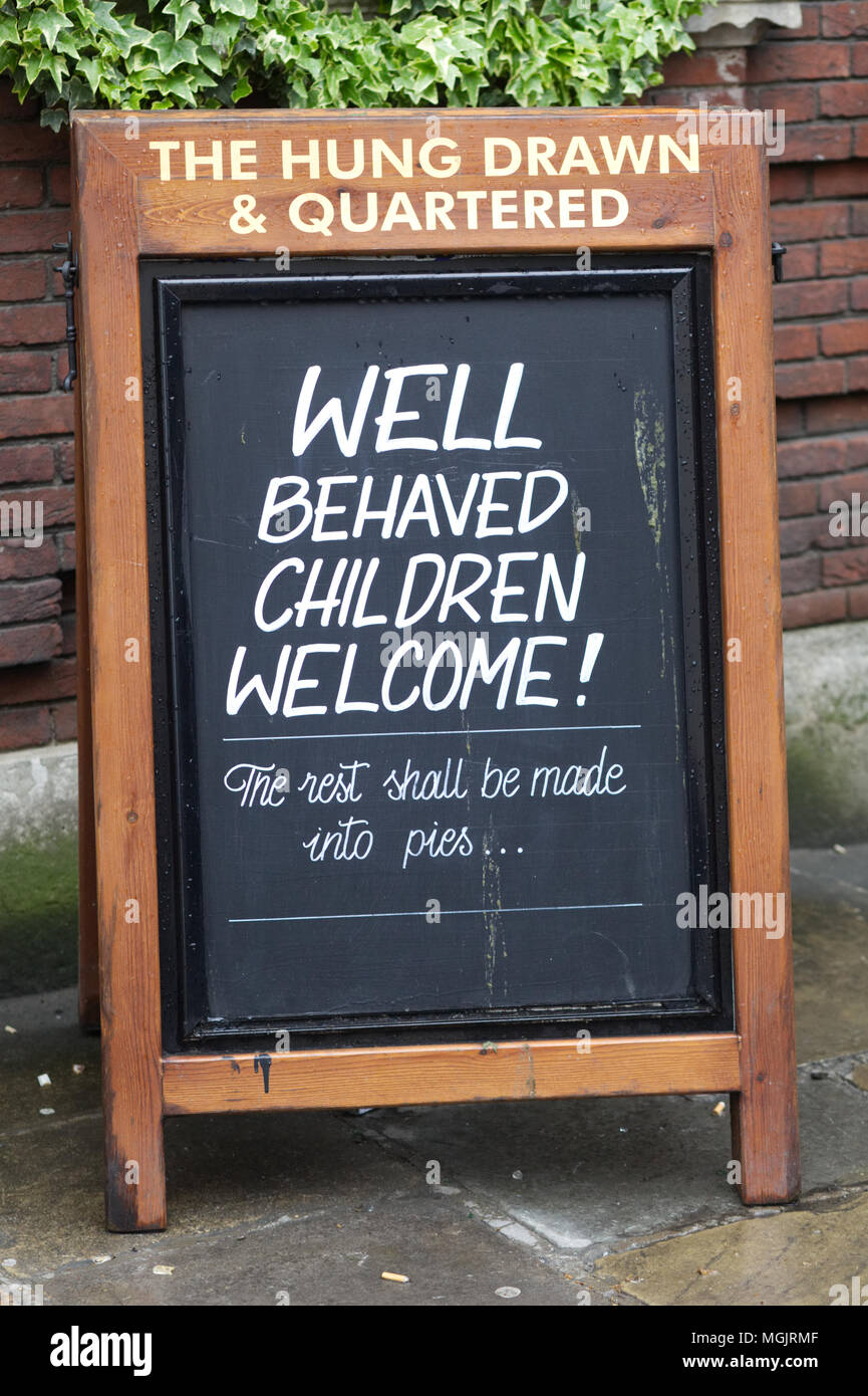 blackboard saying, Well behaved children welcome, the rest shall be made into pies, hung drawn and quartered pub, London Stock Photo