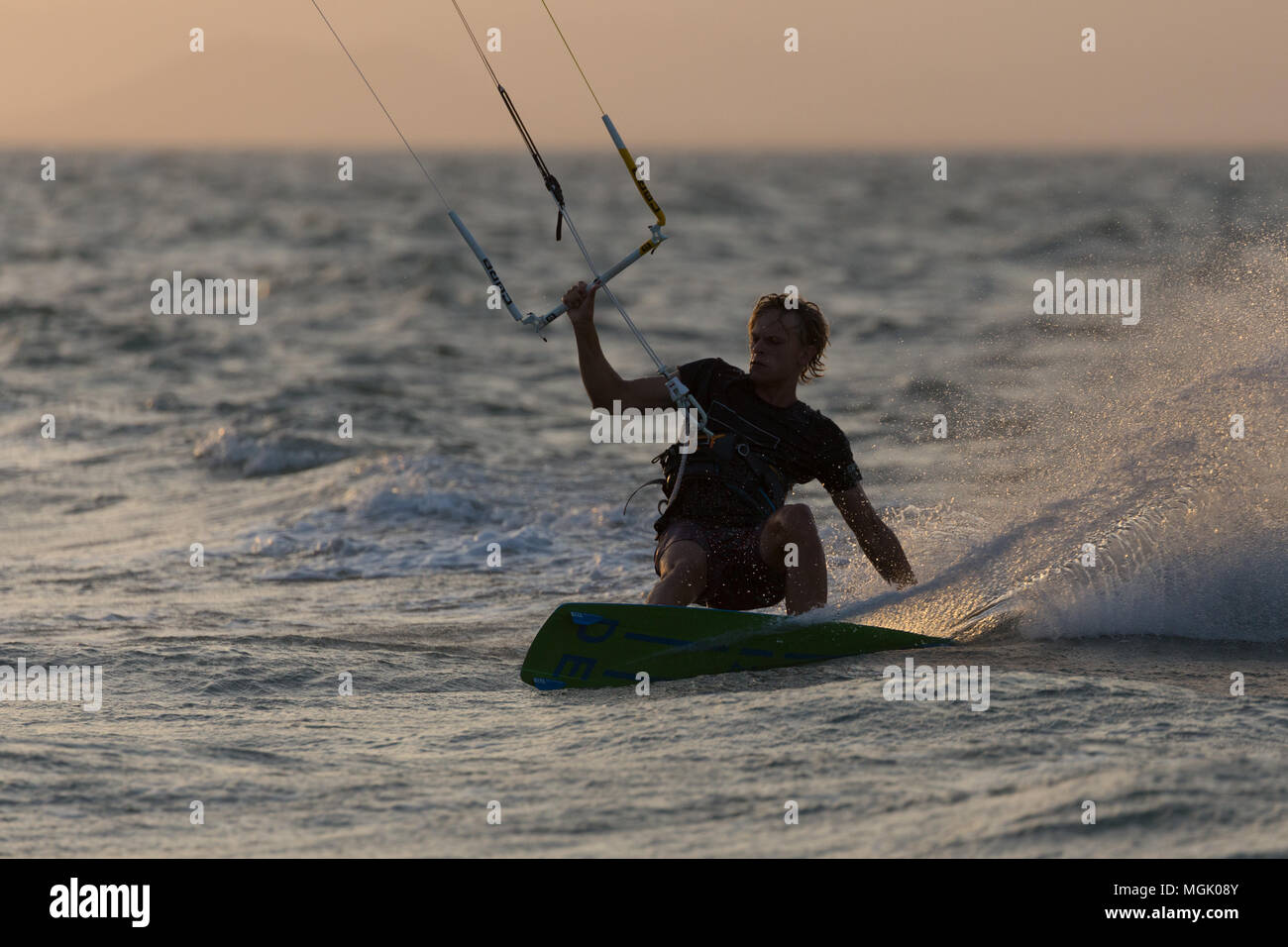 Kitesurfing with lots of spray in Punta Chame lagoon, Panama Stock Photo