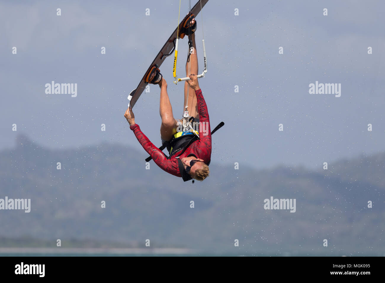 Stunt jumping during a kitesurf session Stock Photo