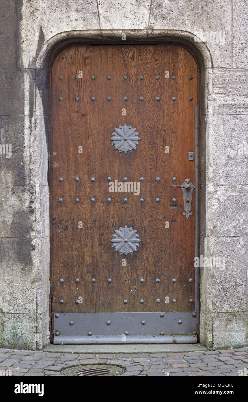 Gray Stone Wall With Vintage Heavy Wooden Door With Rows Of Iron