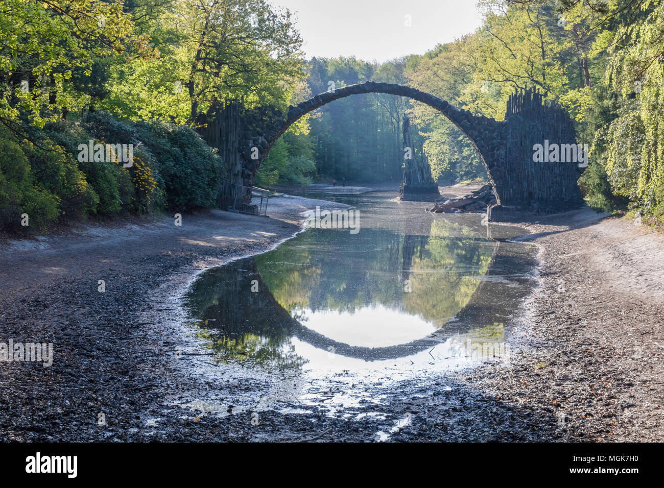 19th century Fairy tale Devil's Bridge (Rakotzbrücke), Saxony, Germany, springtime, sunny day, perfect circle water reflection Stock Photo
