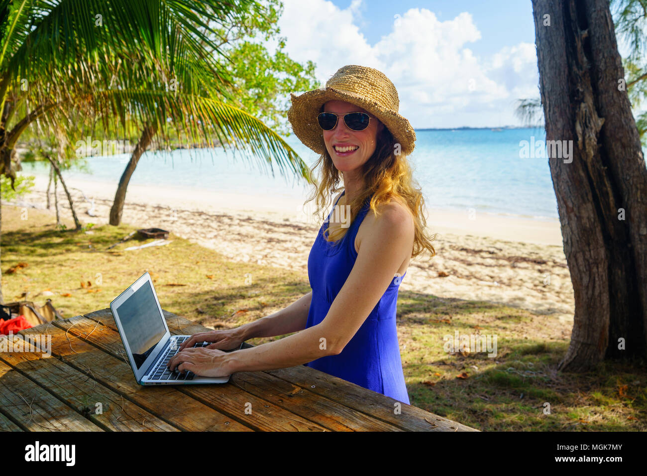 Digital nomad, work from anywhere, laptop with blank screen, tropical