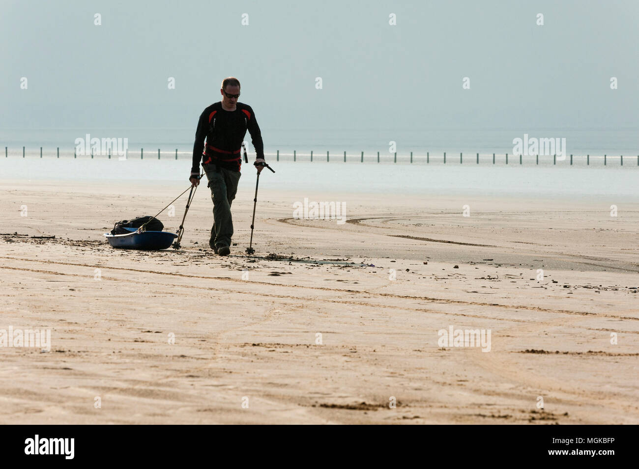 Expedition training on a beach towing a sledge Stock Photo Alamy