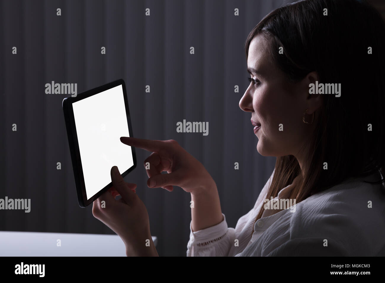 Woman Using Digital Tablet With Blank White Screen Stock Photo