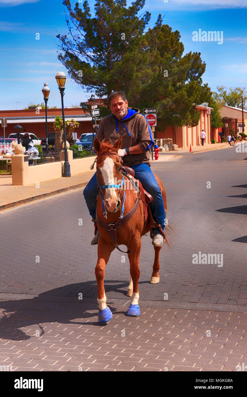Adult male rides his horse through the center of old Las Cruces NM