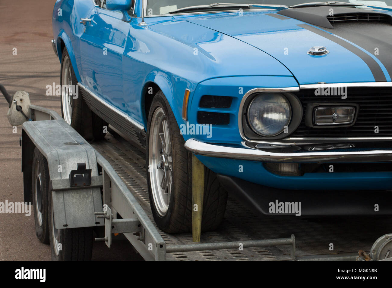 Towing a car. Auto tow truck. Beautiful car, damaged on the trailer