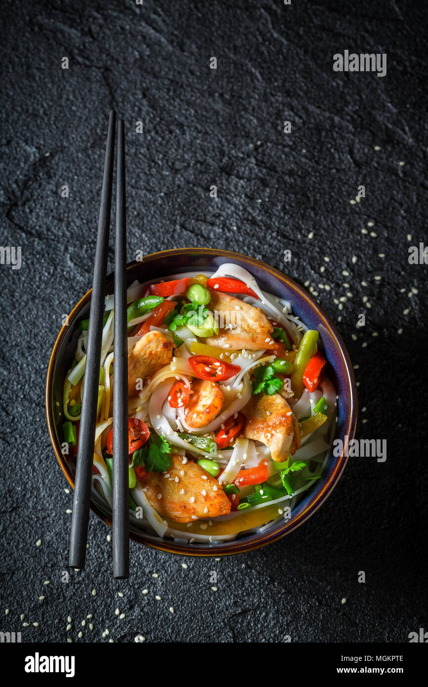 Hot noodle in dark bowl with chopsticks on black rock Stock Photo Alamy