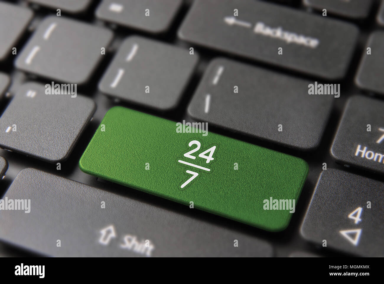 Always open concept for 24 hour internet business, computer keyboard button with 24/7 icon on keypad in green color. Stock Photo