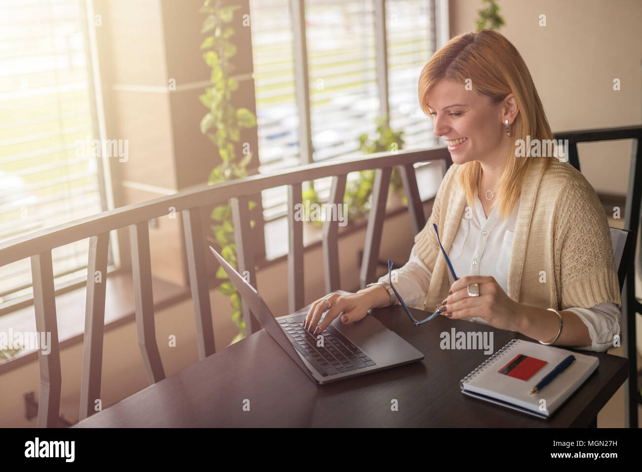 Pretty Young Woman Shopping Online Using Her Credit Card And Laptop
