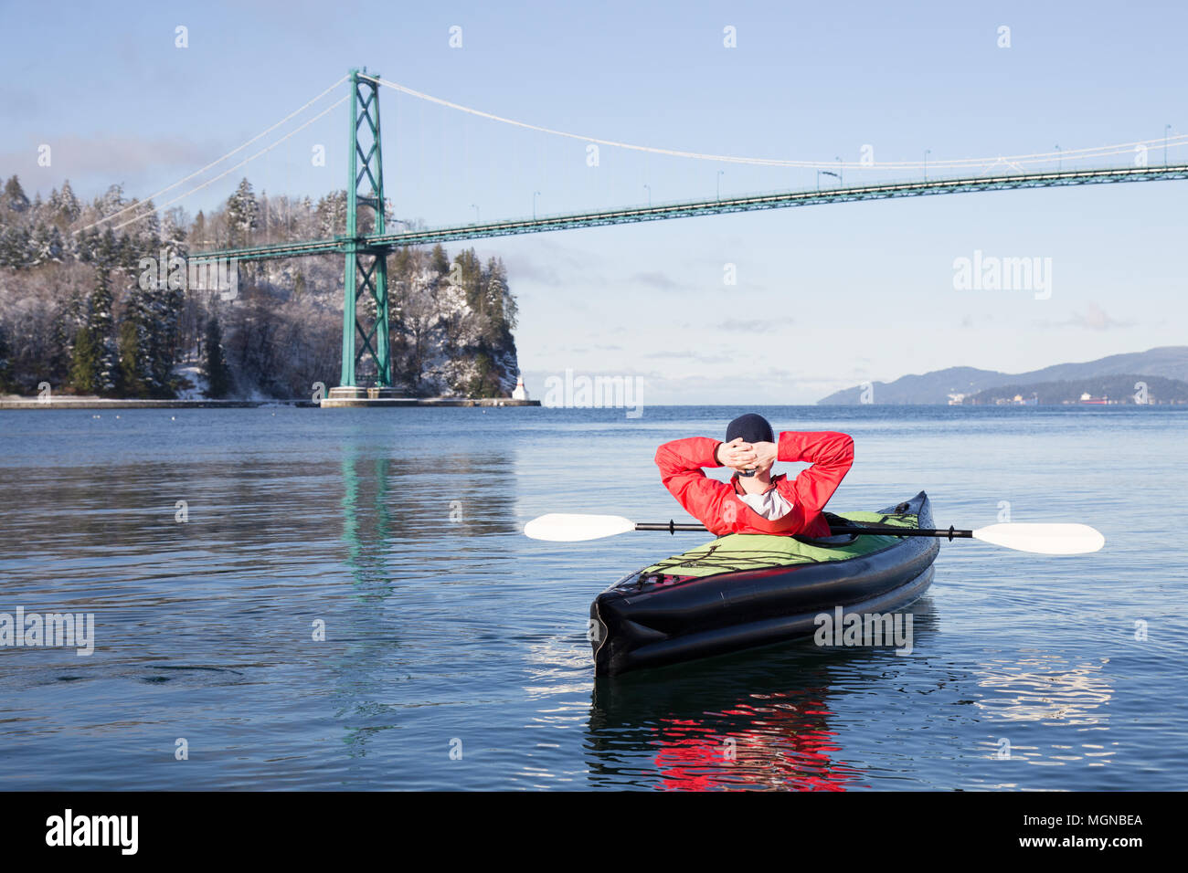Adventurous man kayaking on an inflatable kayak near Lions Gate Bridge