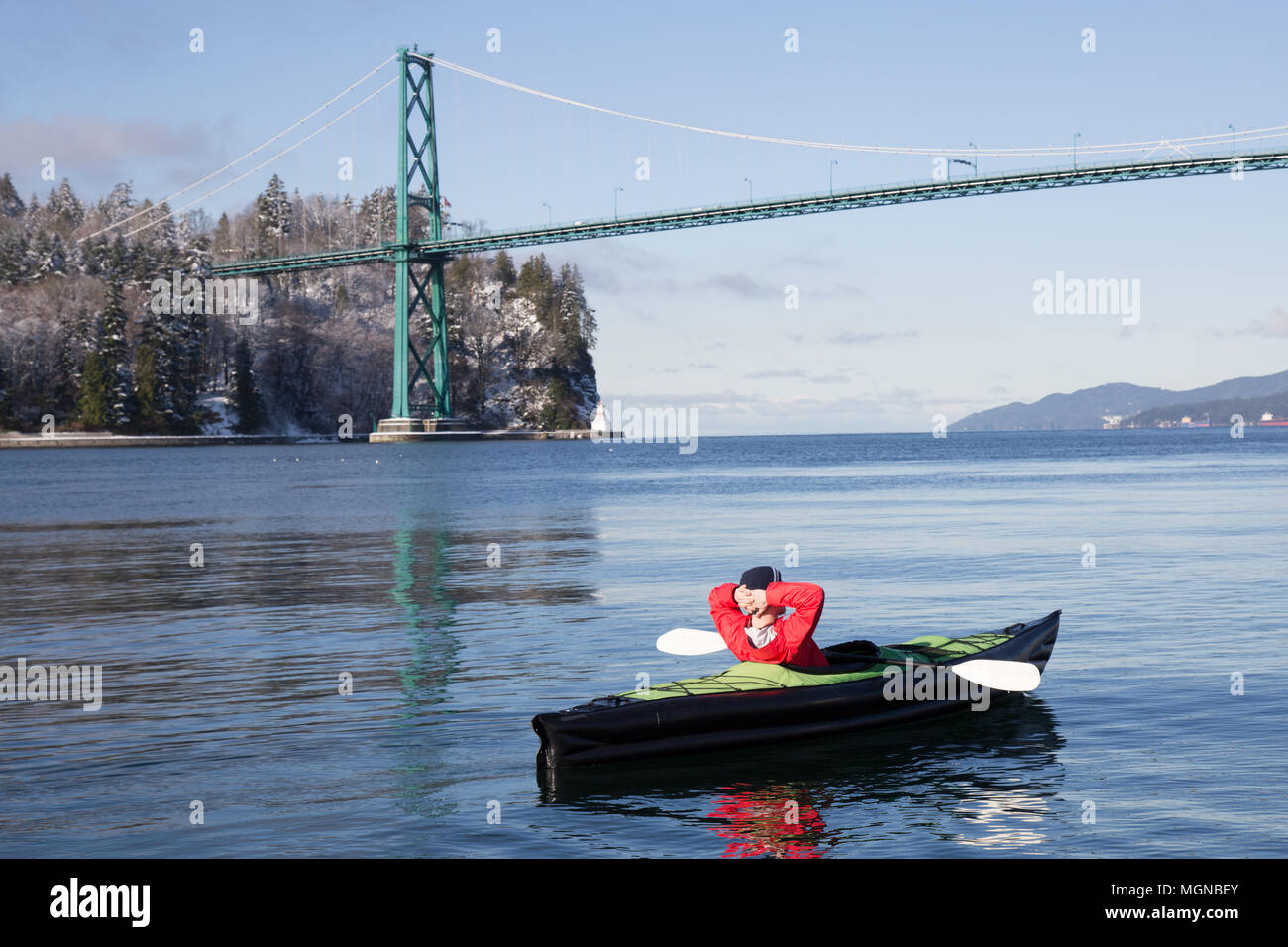 Adventurous man kayaking on an inflatable kayak near Lions Gate Bridge