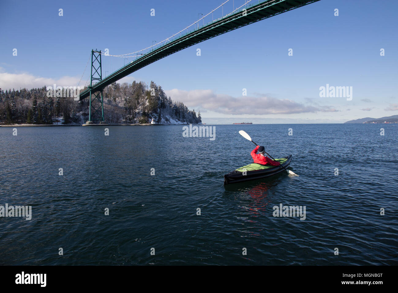 Adventurous man kayaking on an inflatable kayak near Lions Gate Bridge