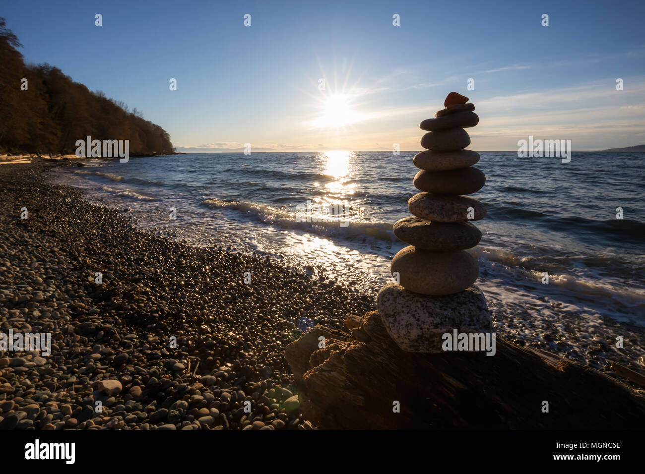 Stack of Rocks piled up by the ocean during a sunny sunset. Taken in