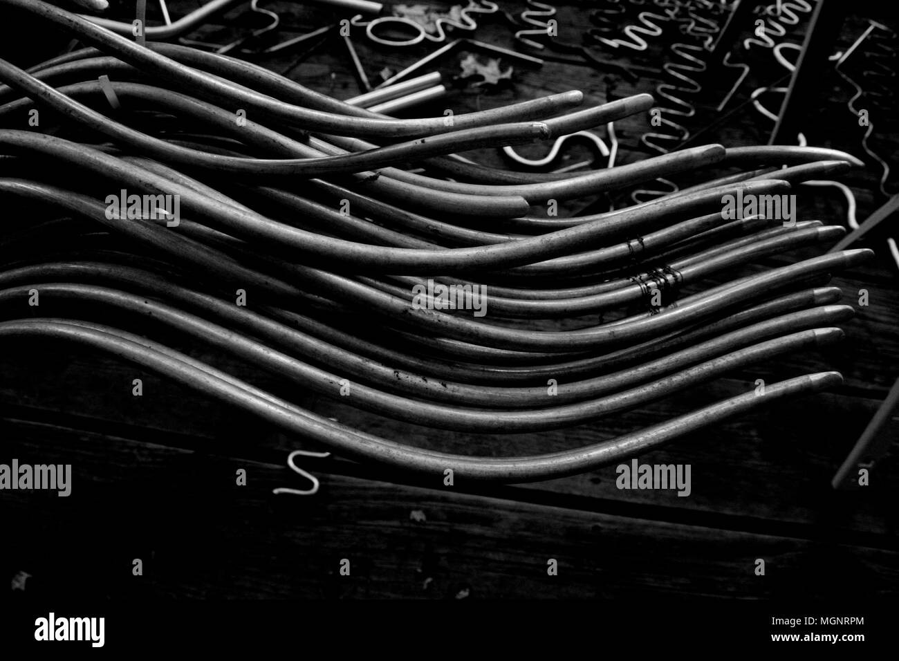 Black and White Metal Alloy Curves on Wooden Bench Stock Photo