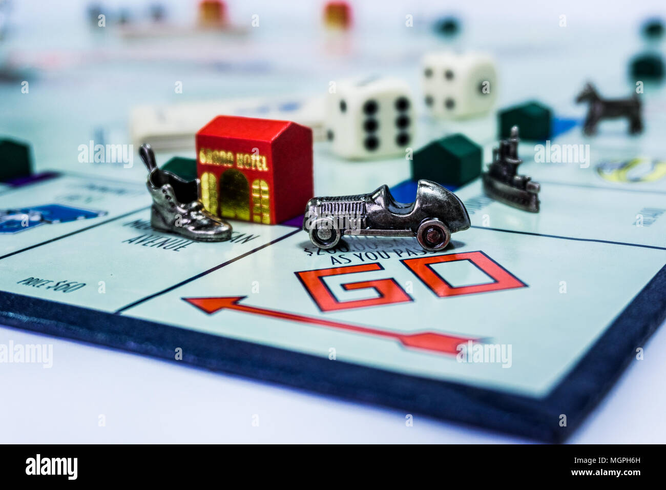 Monopoly Board Game close up with the car passing the GO. Stock Photo