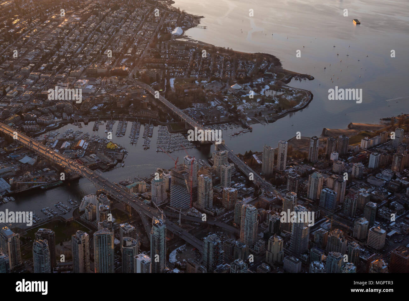 Aerial view of False Creek and Downtown City during a vibrant sunset ...