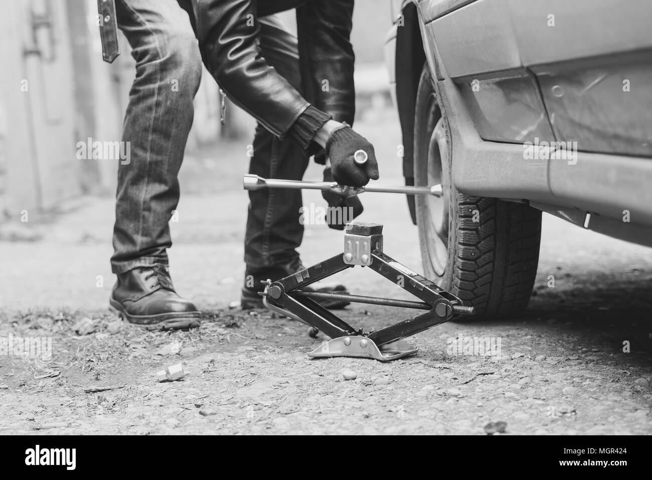 Change a flat car tire on road with Tire maintenance, damaged car tyre ... - Changing Tire On Uneven Side Road