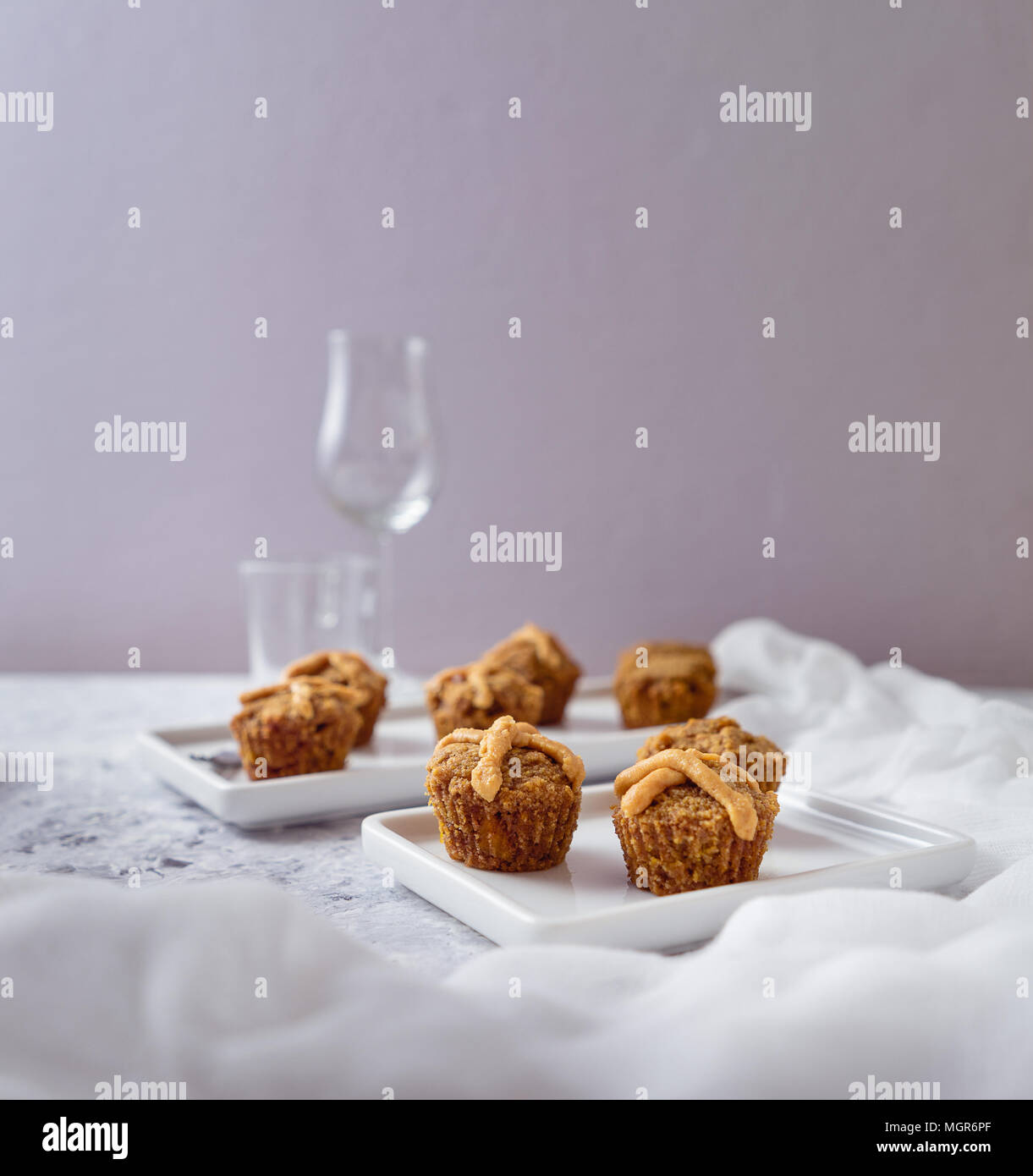 Hot Cross Muffins for Easter, brightly lit table scene Stock Photo