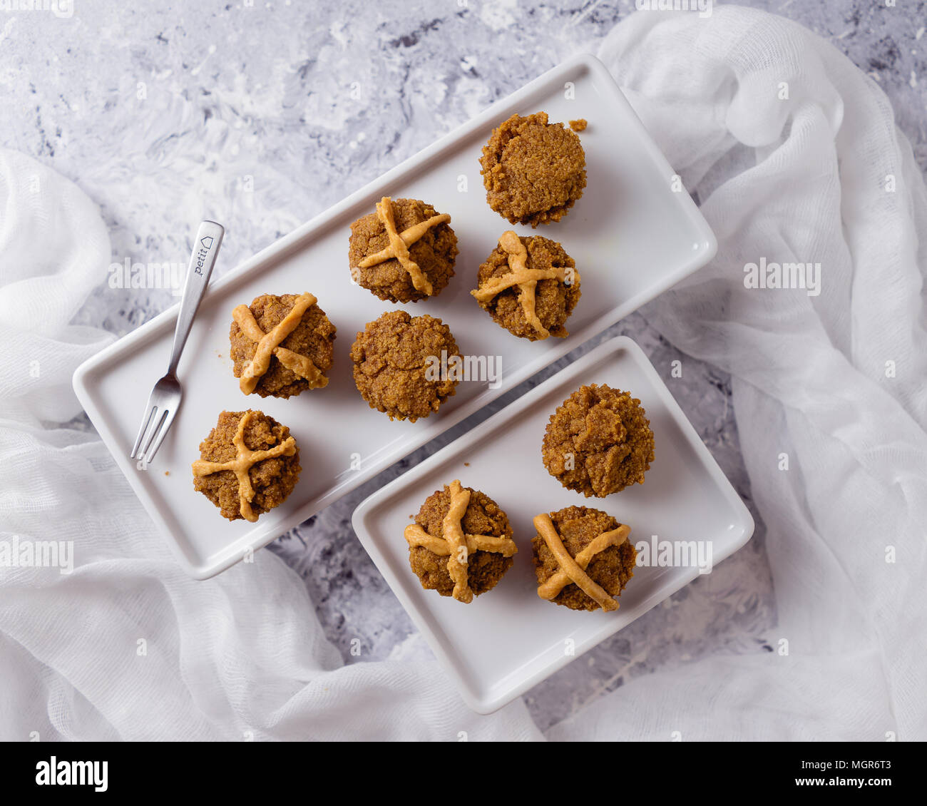 Hot Cross Muffins for Easter, brightly lit table scene Stock Photo