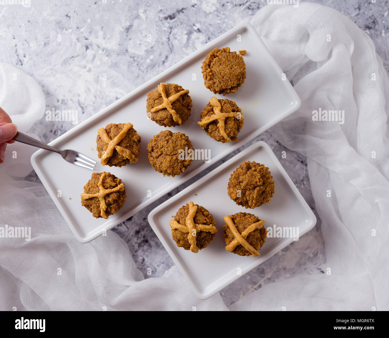 Hot Cross Muffins for Easter, brightly lit table scene Stock Photo