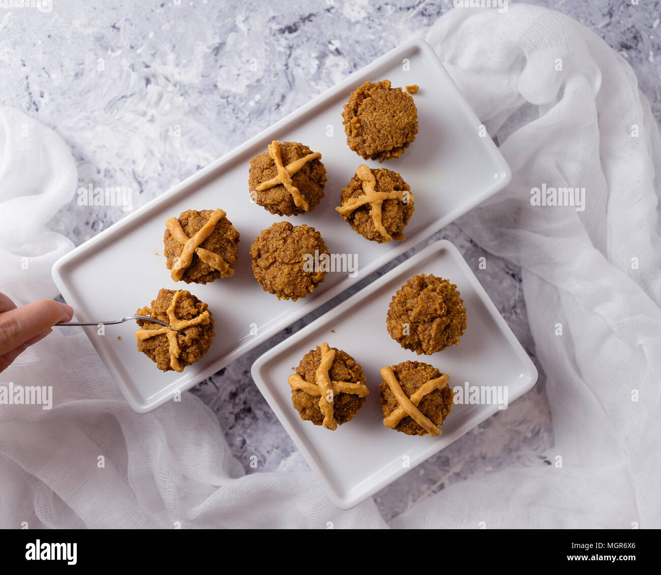 Hot Cross Muffins for Easter, brightly lit table scene Stock Photo