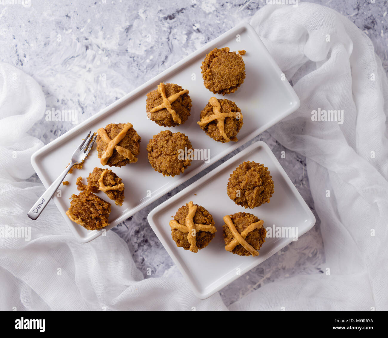 Hot Cross Muffins for Easter, brightly lit table scene Stock Photo