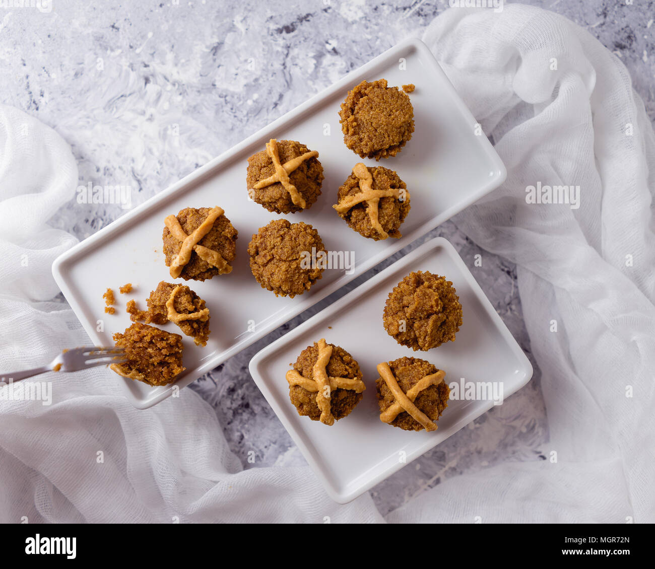 Hot Cross Muffins for Easter, brightly lit table scene Stock Photo