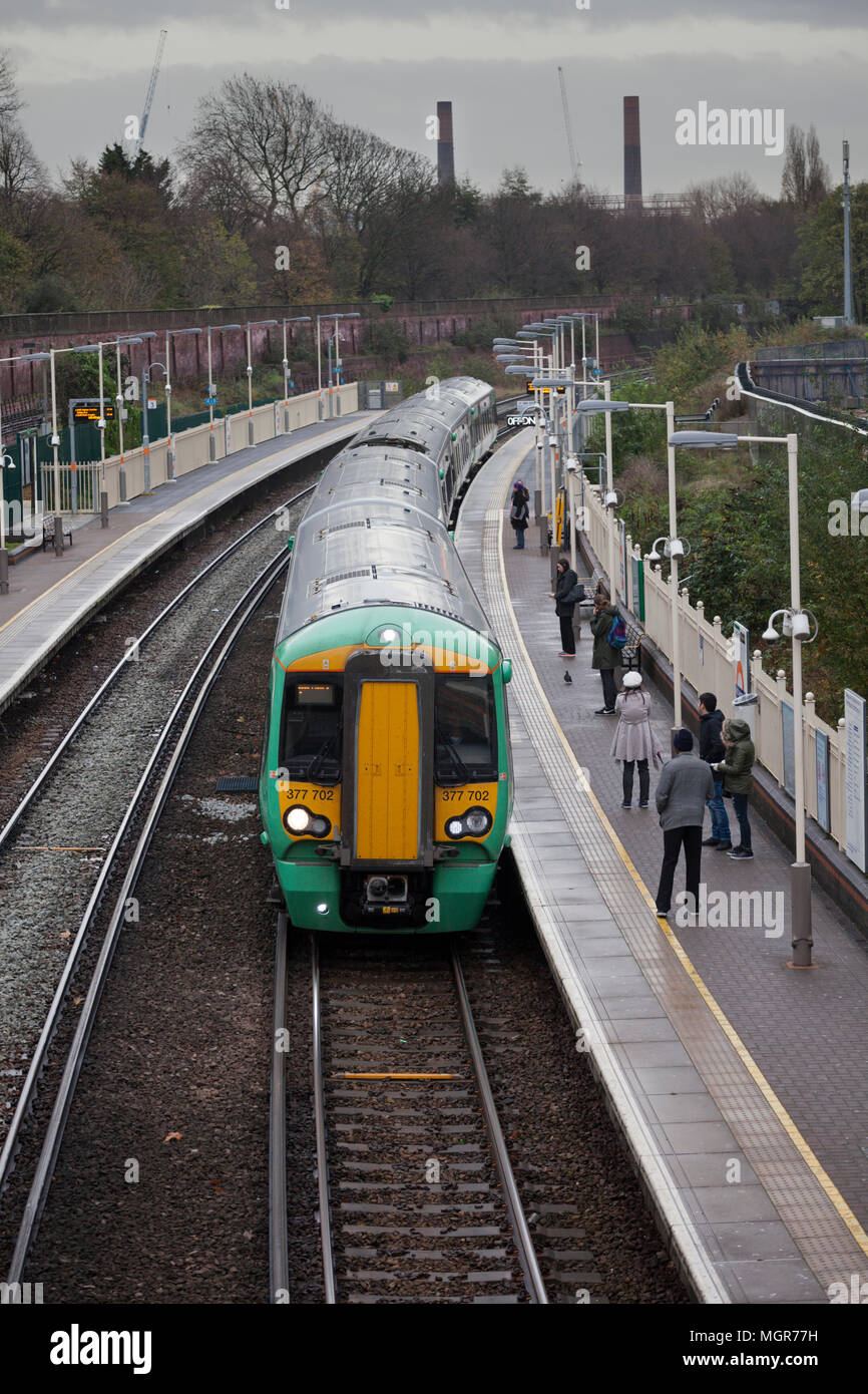 Passengers and a southern railway class 377 electric train at West Brompton on the west London