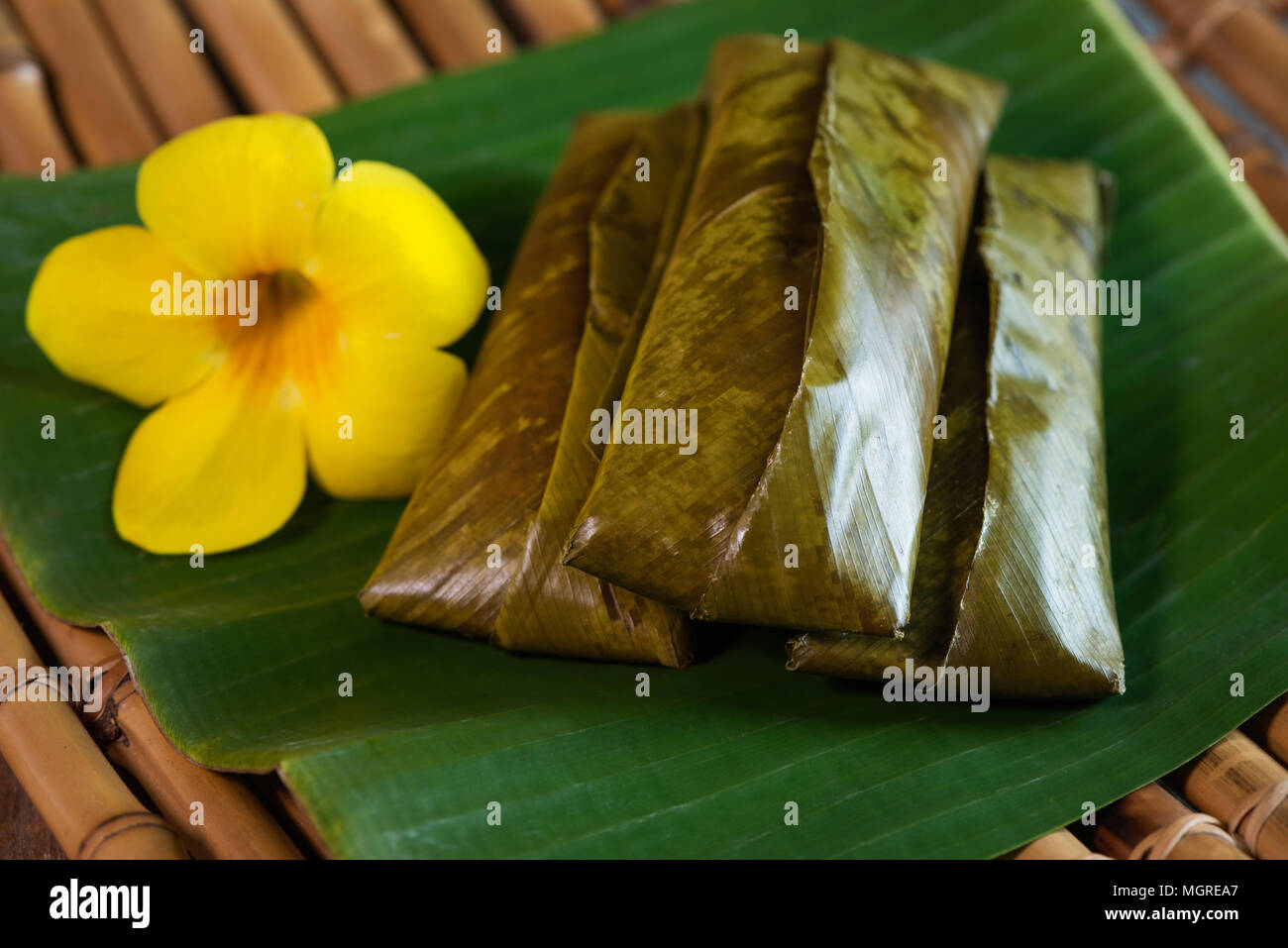 sticky rice wrapped in leaves and served with peanut sauce. Famous ...